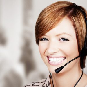 Smiling lady on a headset phone call.